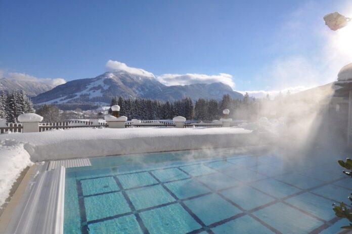 Hotel Alpina Wellness & Spa Resort Winterlicher Pool mit traumhaftem Bergblick Quelle: Hotel Alpina Kössen